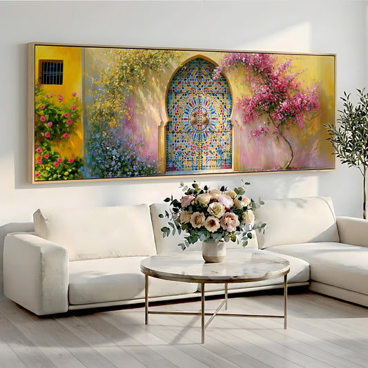 a large, colorful painting of a stained glass window above a white sofa with a vase of flowers on a coffee table in front of it.