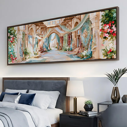 a large, colorful painting of a street scene hanging on a wall above a bed with white bedding and blue pillows.