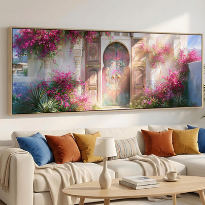 a large, colorful painting of a garden scene with a pink and green floral archway, hanging on a wall above a white sofa with colorful throw pillows.