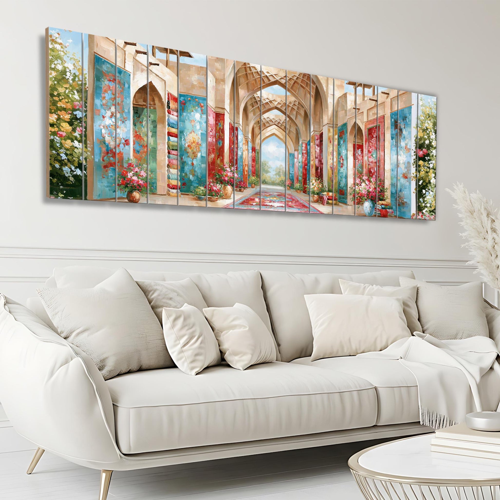 a large, colorful painting of an ornate hallway or corridor, with intricate architectural details and vibrant colors. The painting is displayed on a wall above a white sofa, creating a striking visual focal point in the room.
