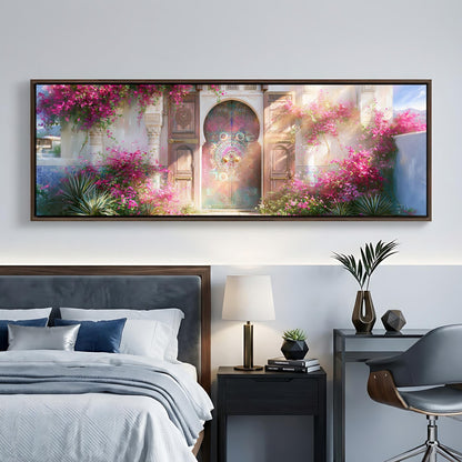 a large, colorful painting of a garden with a pink archway and flowers hanging from the archway, hanging on a wall above a bed with a gray headboard.