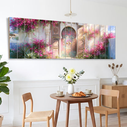 a dining area with a table set for two, featuring a vase of flowers, a plate of pastries, and two chairs. Above the table, there is a large, colorful painting depicting a garden scene with pink flowers and a colorful archway.