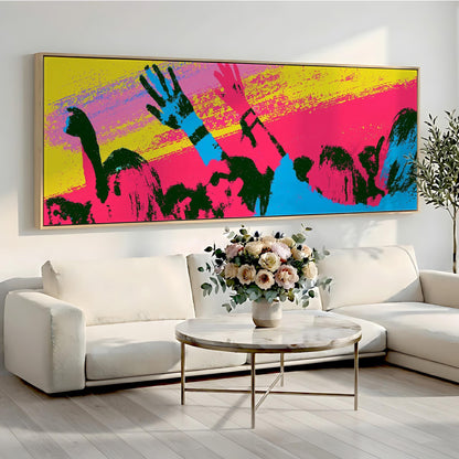 a large, colorful abstract painting hanging on a wall above a white sofa and a round coffee table with a vase of flowers.