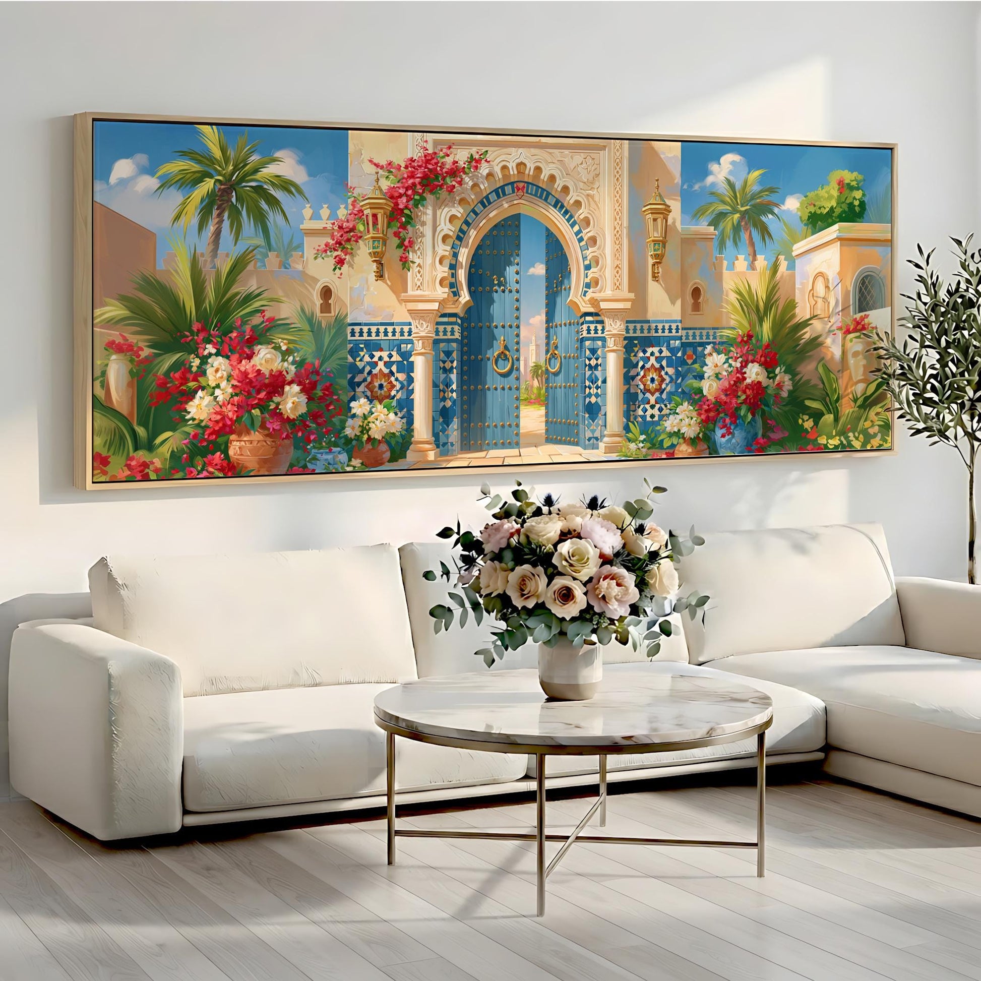 a large, colorful painting of an ornate gate and lush tropical foliage hanging on a wall above a white sofa and a round coffee table.