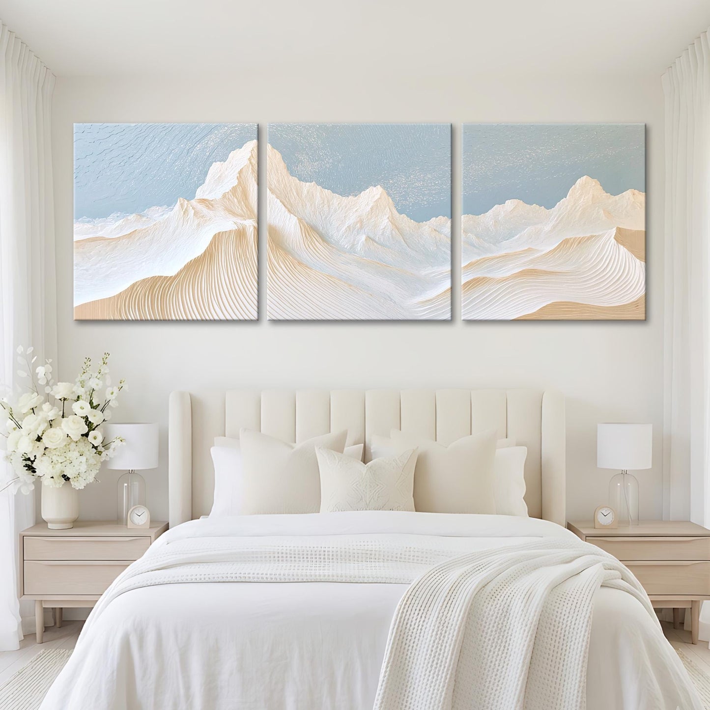 A serene bedroom with a large bed, white bedding, and a large painting of a mountain landscape above it.