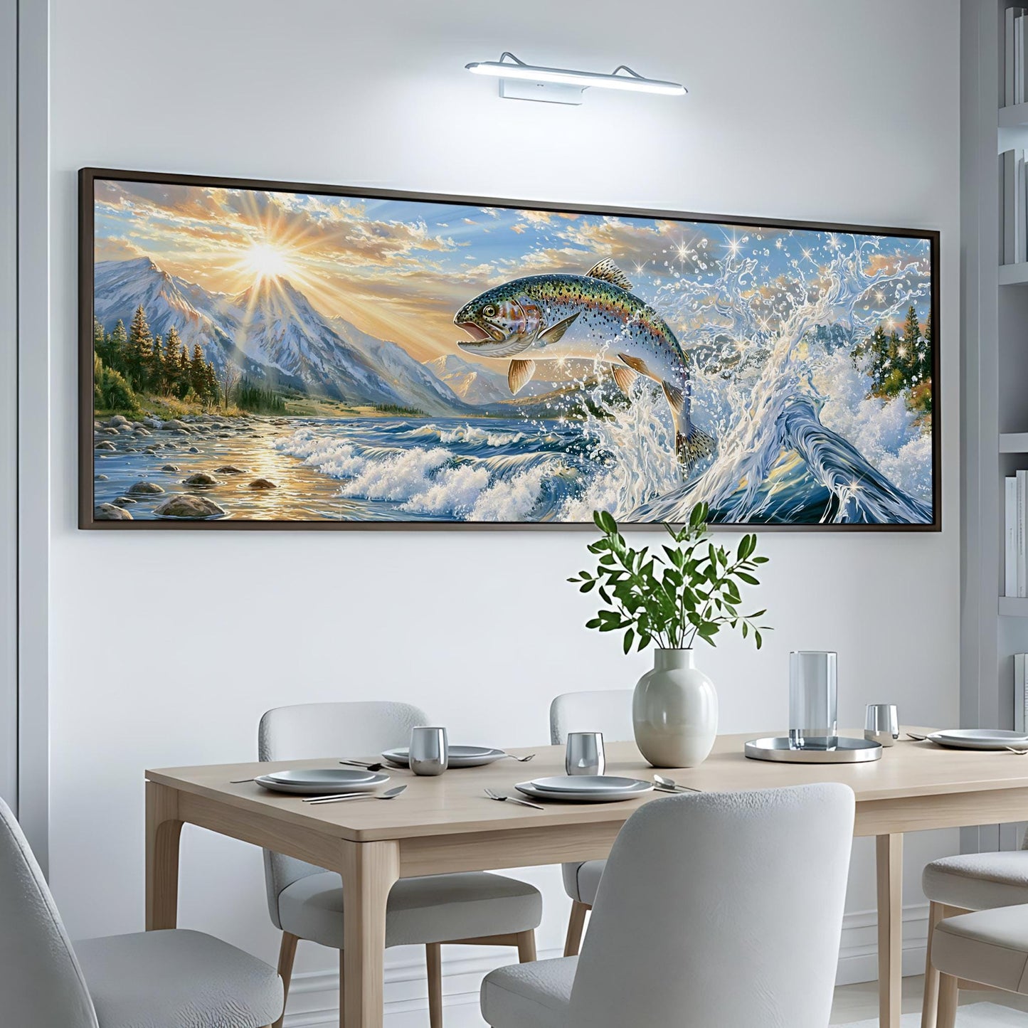 a large, colorful painting of a fish leaping out of the water, set against a backdrop of mountains and a sunset. The painting is hung on a white wall above a wooden dining table, which is set with plates, silverware, and a vase of flowers.