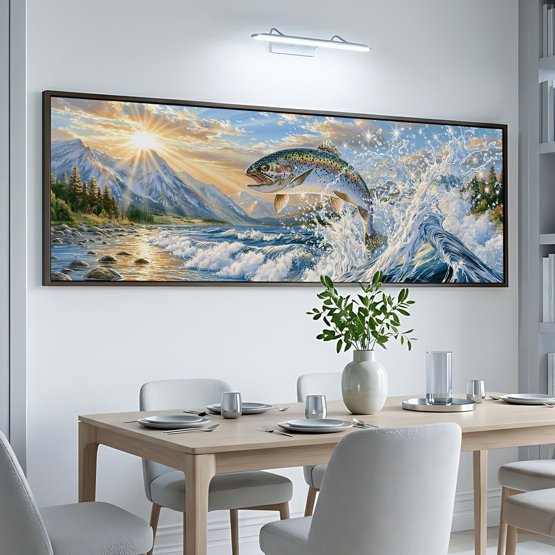 a large, colorful painting of a fish leaping out of the water, set against a backdrop of mountains and a sunset. The painting is hung on a white wall above a wooden dining table, which is set with plates, silverware, and a vase of flowers.