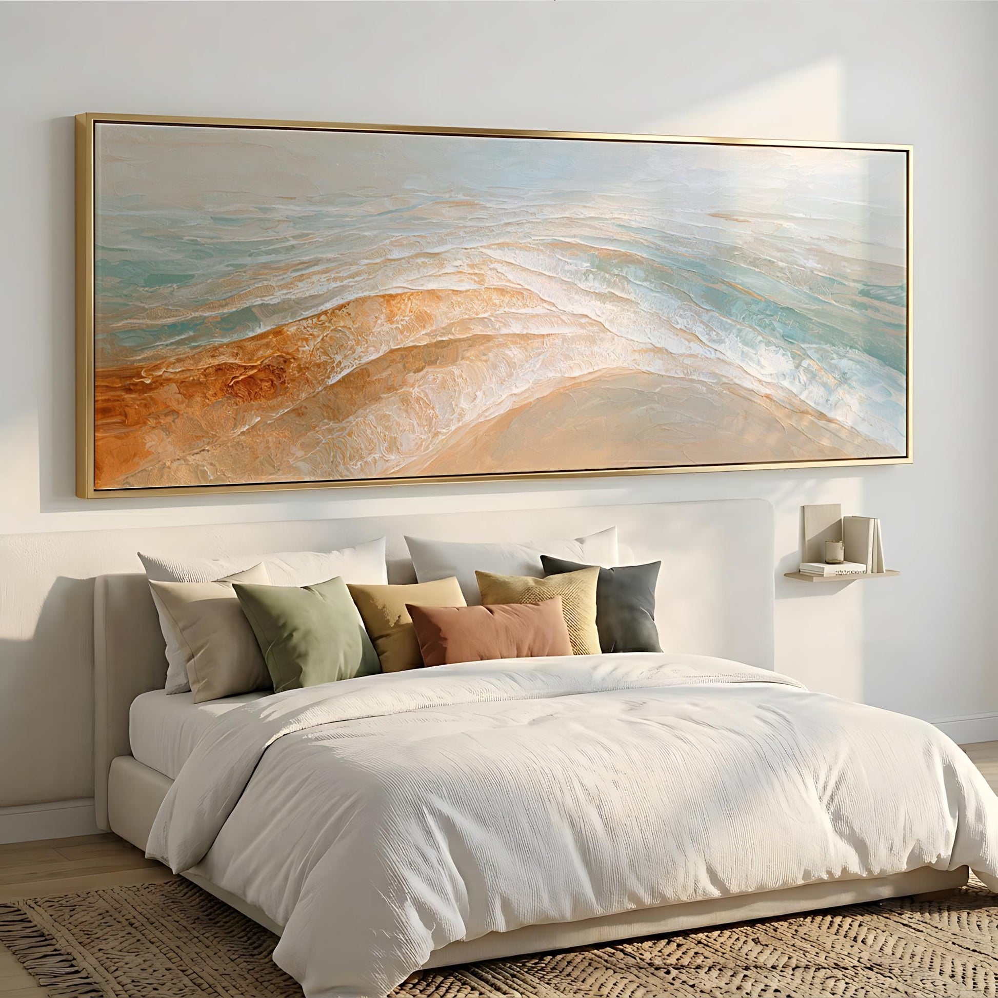 a large, white bed with a white comforter and pillows, and a large, framed painting of a beach scene above it.