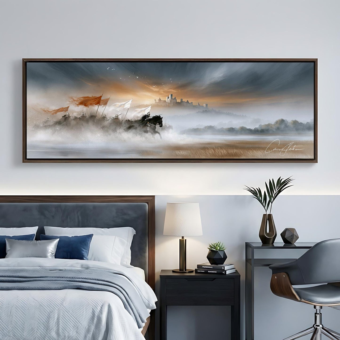 a large, framed painting of a serene landscape hanging on a wall above a bed with a gray headboard. The painting depicts a misty, foggy scene with a castle in the distance, surrounded by trees and mountains. The room also includes a nightstand with a lamp, a chair, and a plant, creating a cozy and inviting atmosphere.