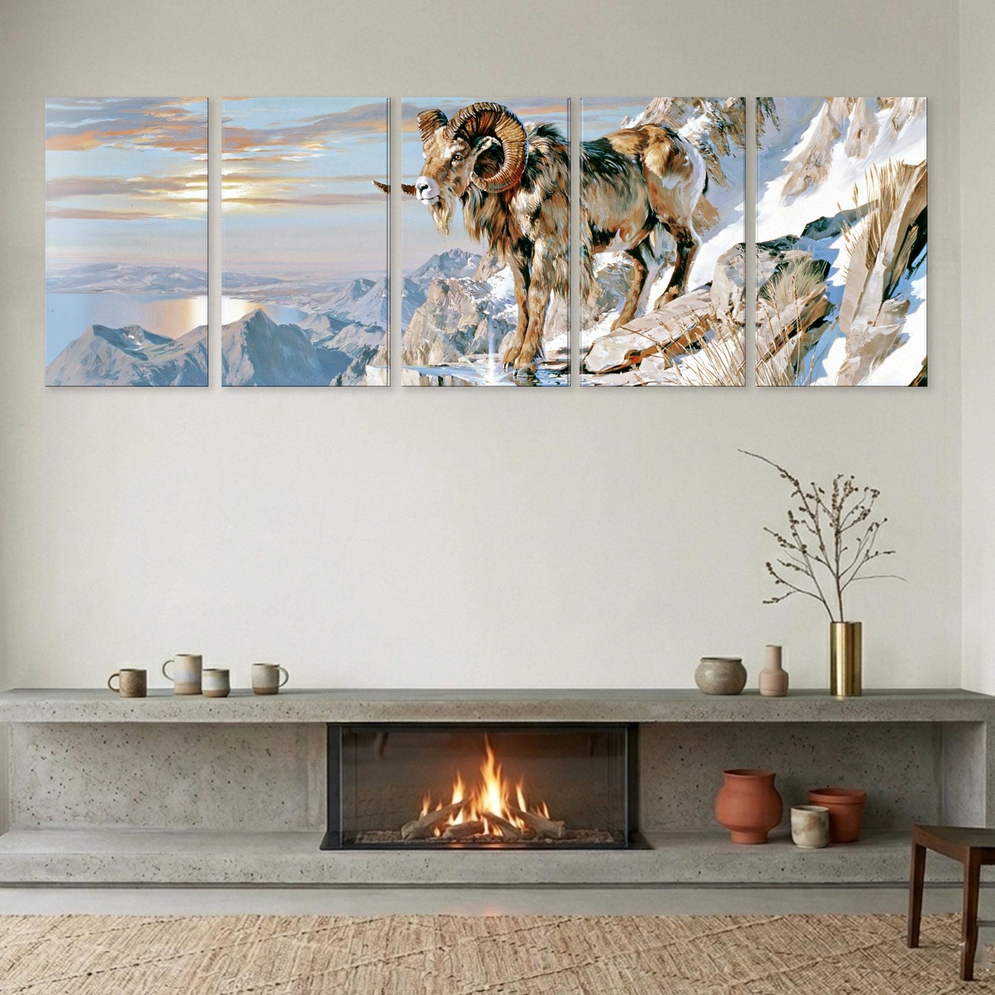 a fireplace with a large painting of a mountain goat above it. The painting depicts a majestic mountain goat standing on a rocky cliff, overlooking a scenic landscape. The fireplace has a vase and a plant on the mantel, adding a touch of warmth and nature to the room.
