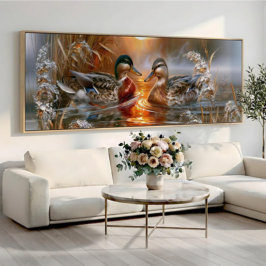 a large painting of two ducks swimming in a pond, with a vase of flowers on a table in front of the painting.