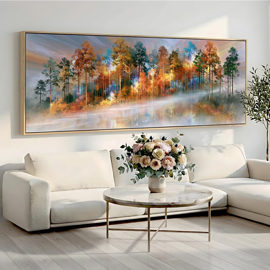 a large painting of a forest scene hanging on a wall above a white sofa and a round coffee table with a vase of flowers.