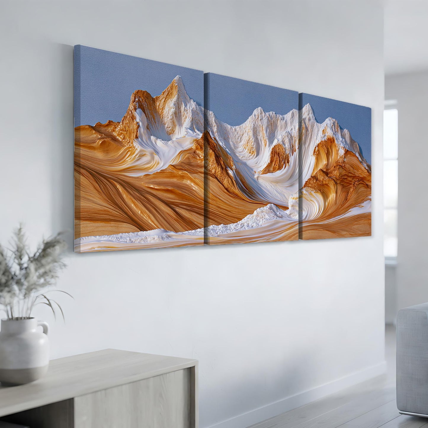 a large, three-part landscape painting depicting a mountain range with a swirling, golden-orange color scheme.