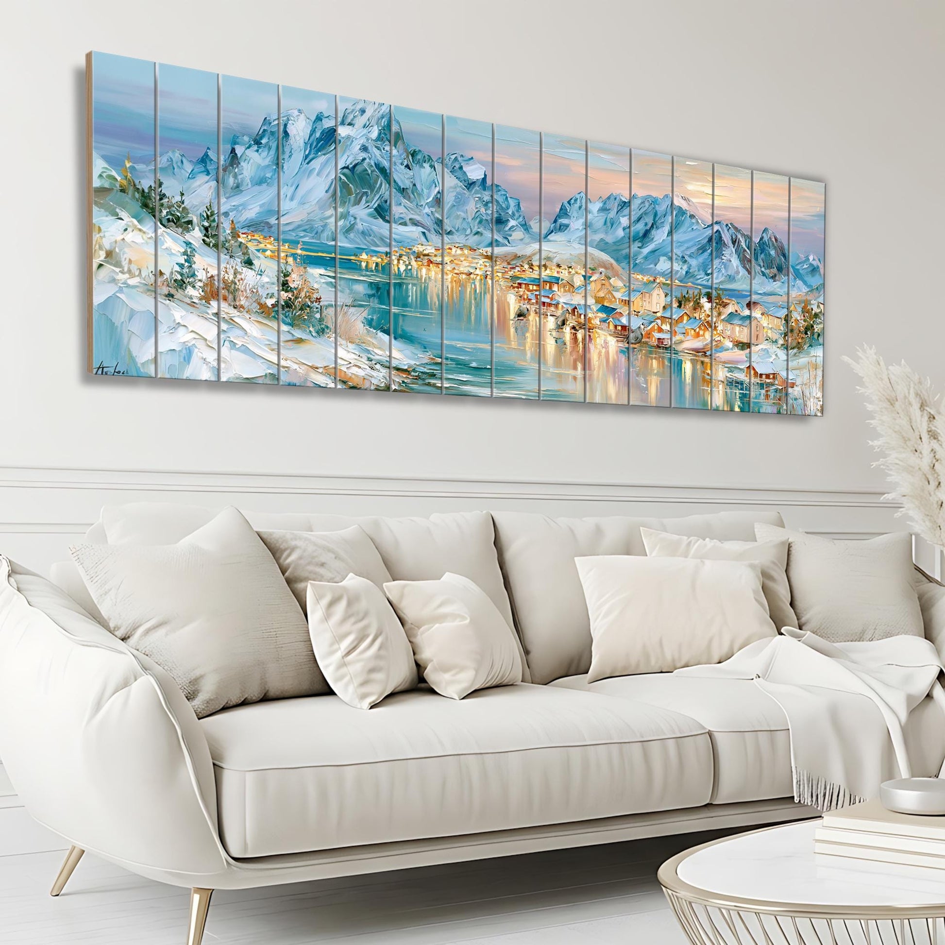 a large, colorful painting of a snowy mountain landscape with a town in the background, hanging on a wall above a white couch in a living room setting.