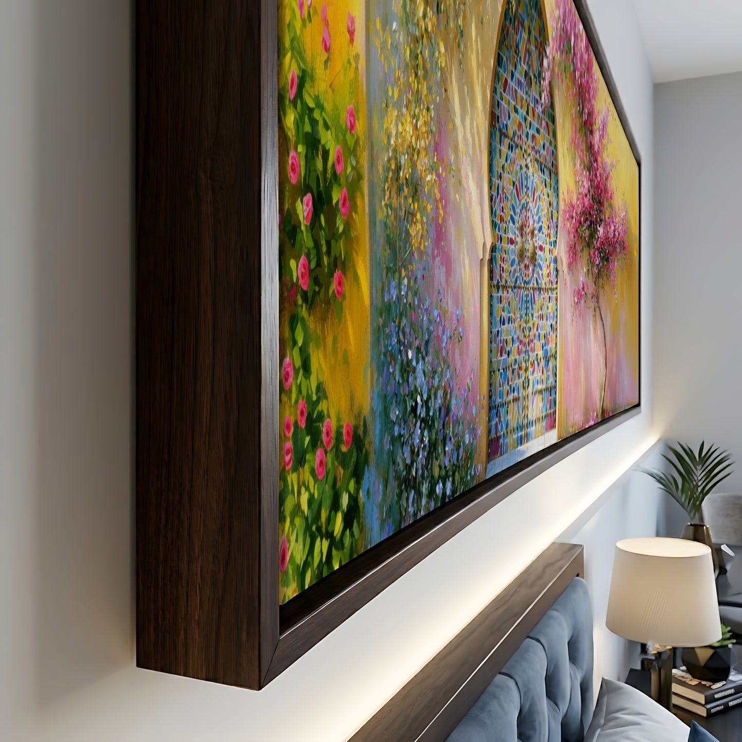 a large, colorful painting of a garden scene with flowers and a gate, displayed on a wall above a bedside table.