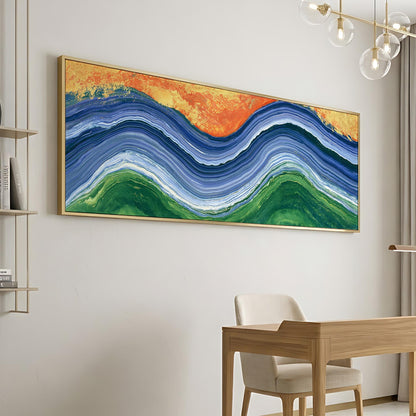 a large abstract painting hanging on a white wall, depicting a colorful wave-like pattern in shades of blue, green, and orange. In the foreground, there is a wooden desk with a chair, suggesting a workspace or study area.