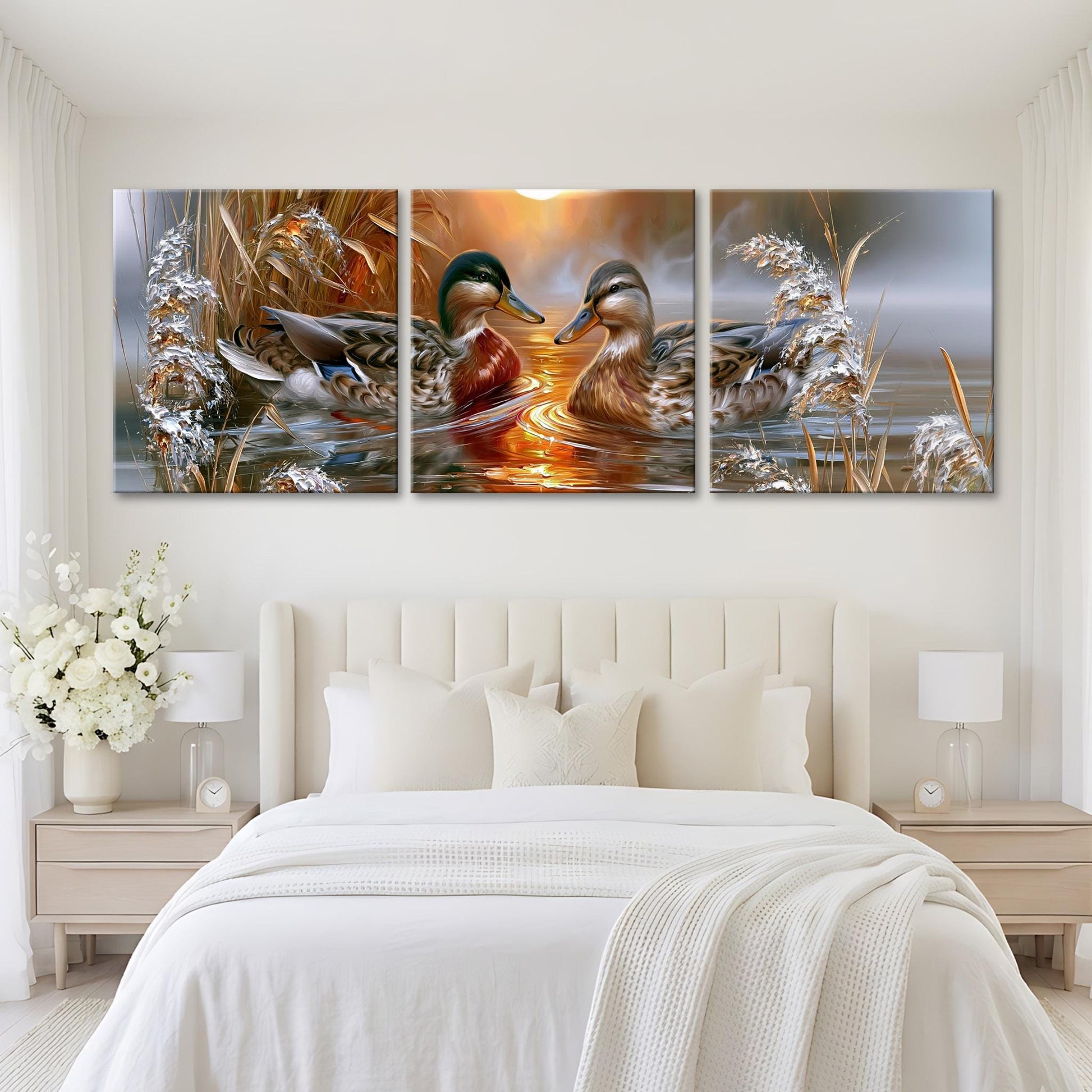A large, three-panel painting depicting ducks swimming in a body of water, with a warm, golden sunset in the background.