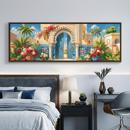 a large, colorful painting of an ornate, blue-trimmed gate with a yellow archway, surrounded by tropical plants and flowers, hanging above a bed with a gray headboard.