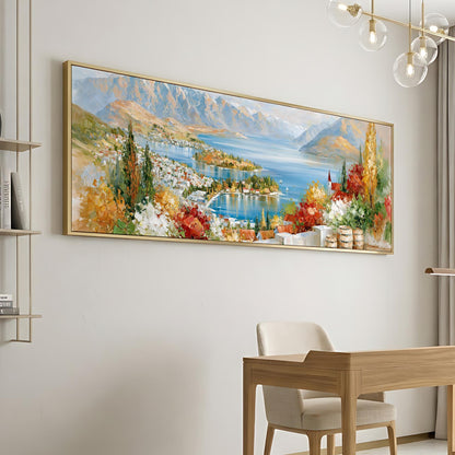 a large, colorful painting of a scenic landscape hanging on a wall, depicting a picturesque town nestled by a lake.