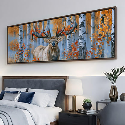 a large framed painting of a deer with antlers in a forest setting, hanging on a wall above a bed with white bedding.