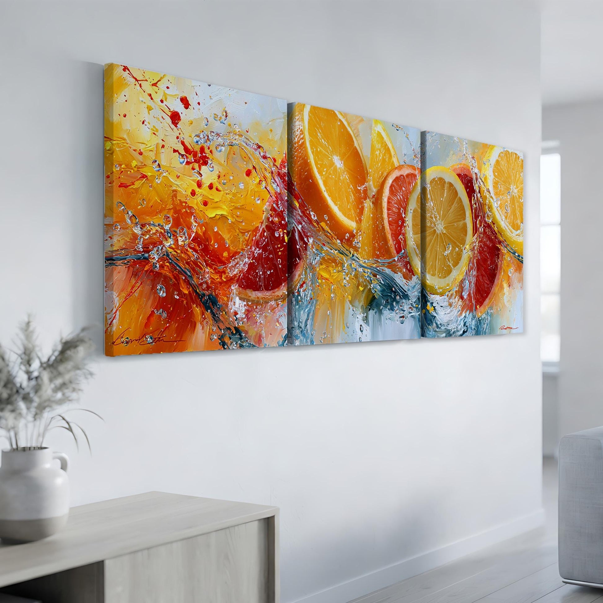 a large, vibrant painting of oranges and splashes of color, hanging on a white wall in a room.