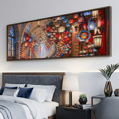 a large, colorful painting of a lantern-filled room hanging on a wall above a bed.