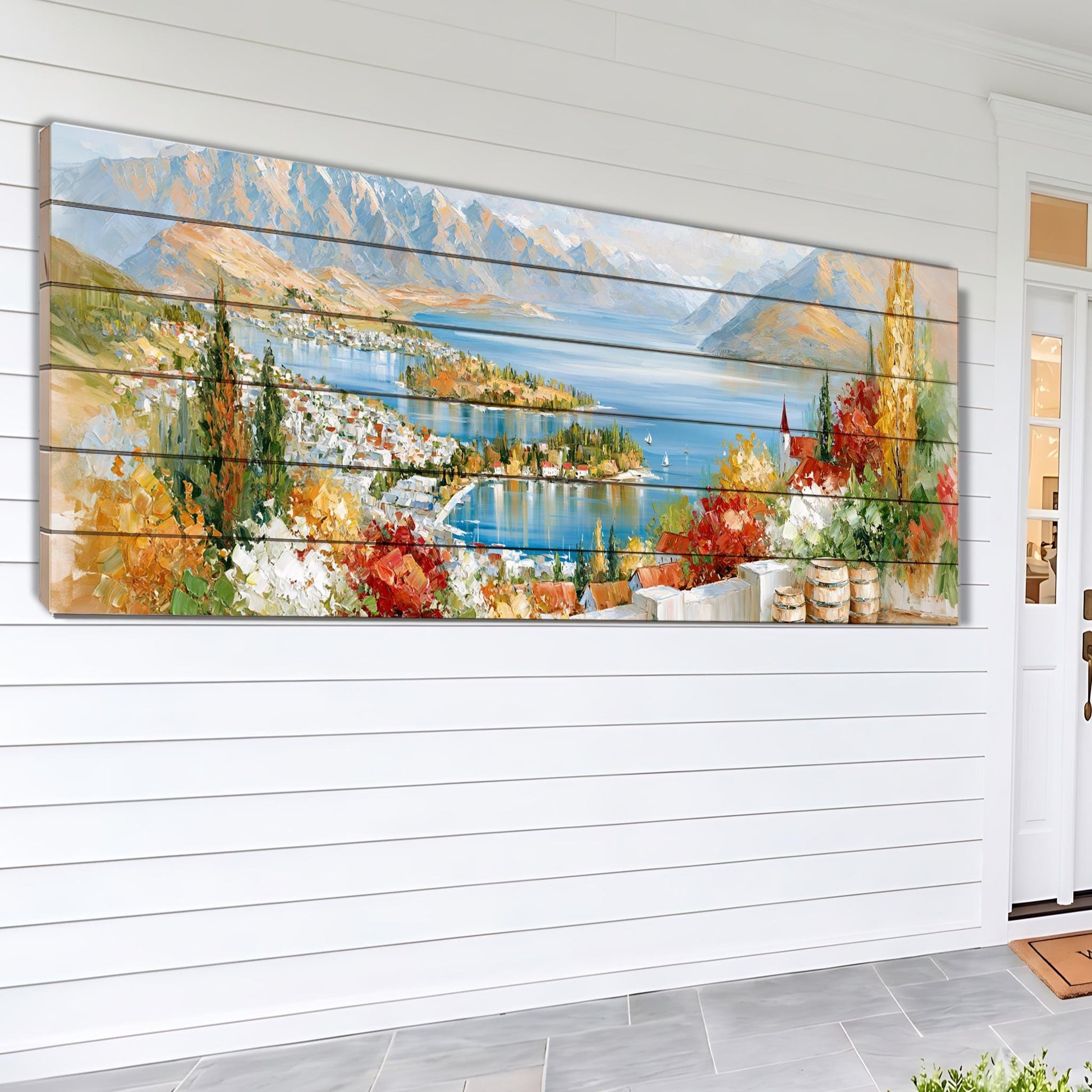 The image is a large, colorful painting depicting a scenic landscape with mountains, a lake, and a town in the distance.