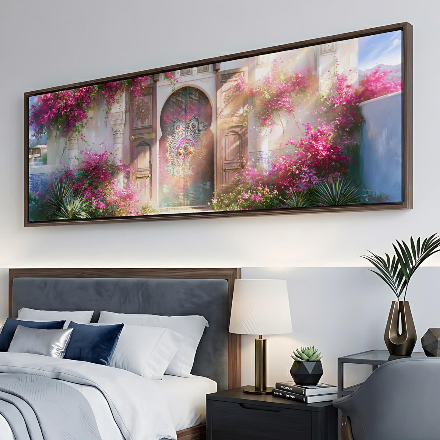 a large, colorful painting of a building with pink flowers hanging above a bed in a bedroom setting.