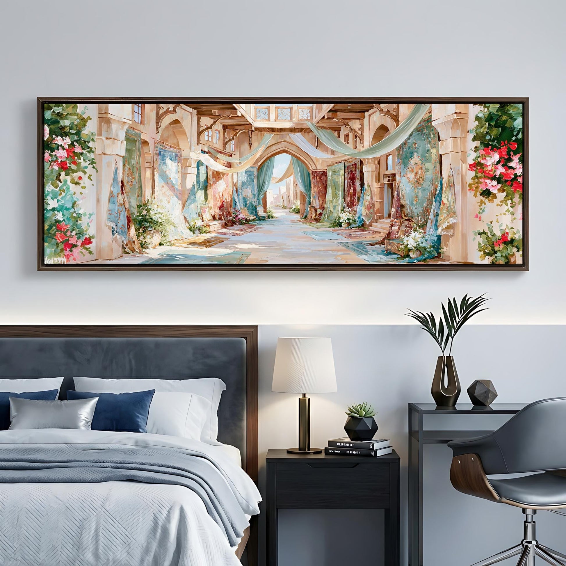 a large, colorful painting of an ornate, arched hallway with floral decorations hanging from the ceiling. The painting is displayed on a wall above a bed with a gray headboard. The room also includes a nightstand with a lamp, a chair, and a small table with decorative items.