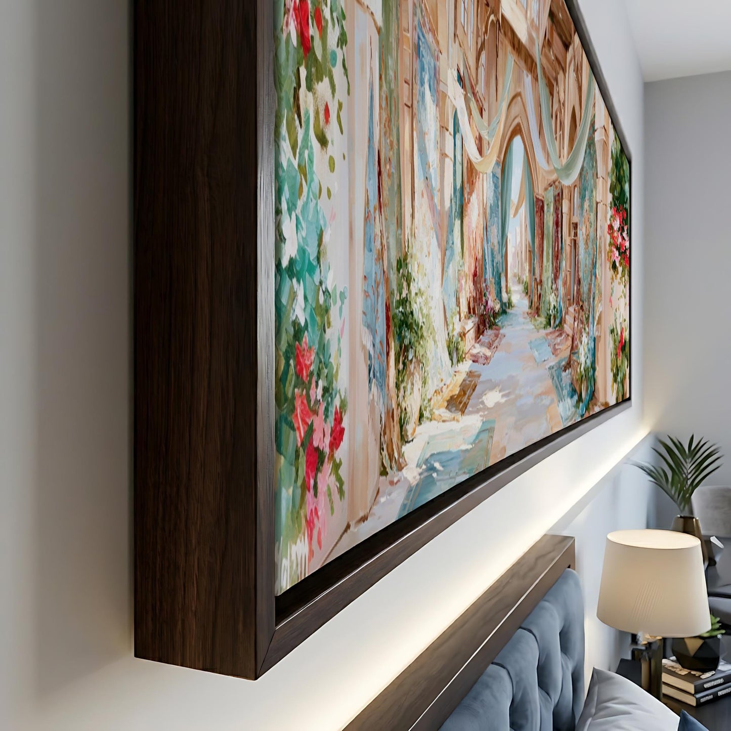 a large, colorful painting of a street scene with buildings, flowers, and a winding path. The painting is framed and displayed on a wall, creating a focal point in the room.