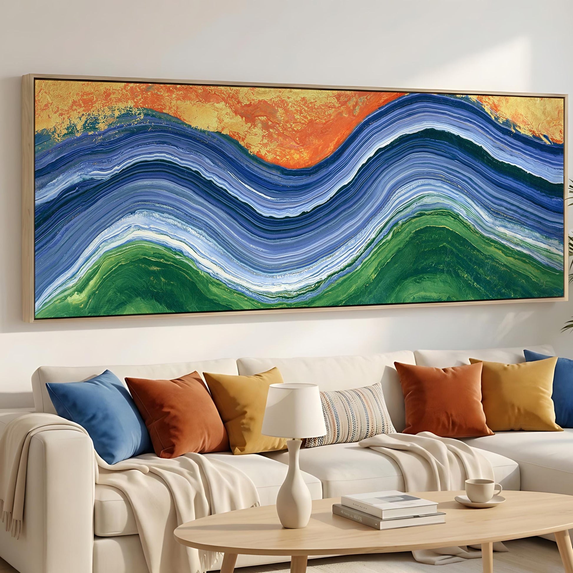 a large, colorful abstract painting hanging on a wall above a white couch with various throw pillows.
