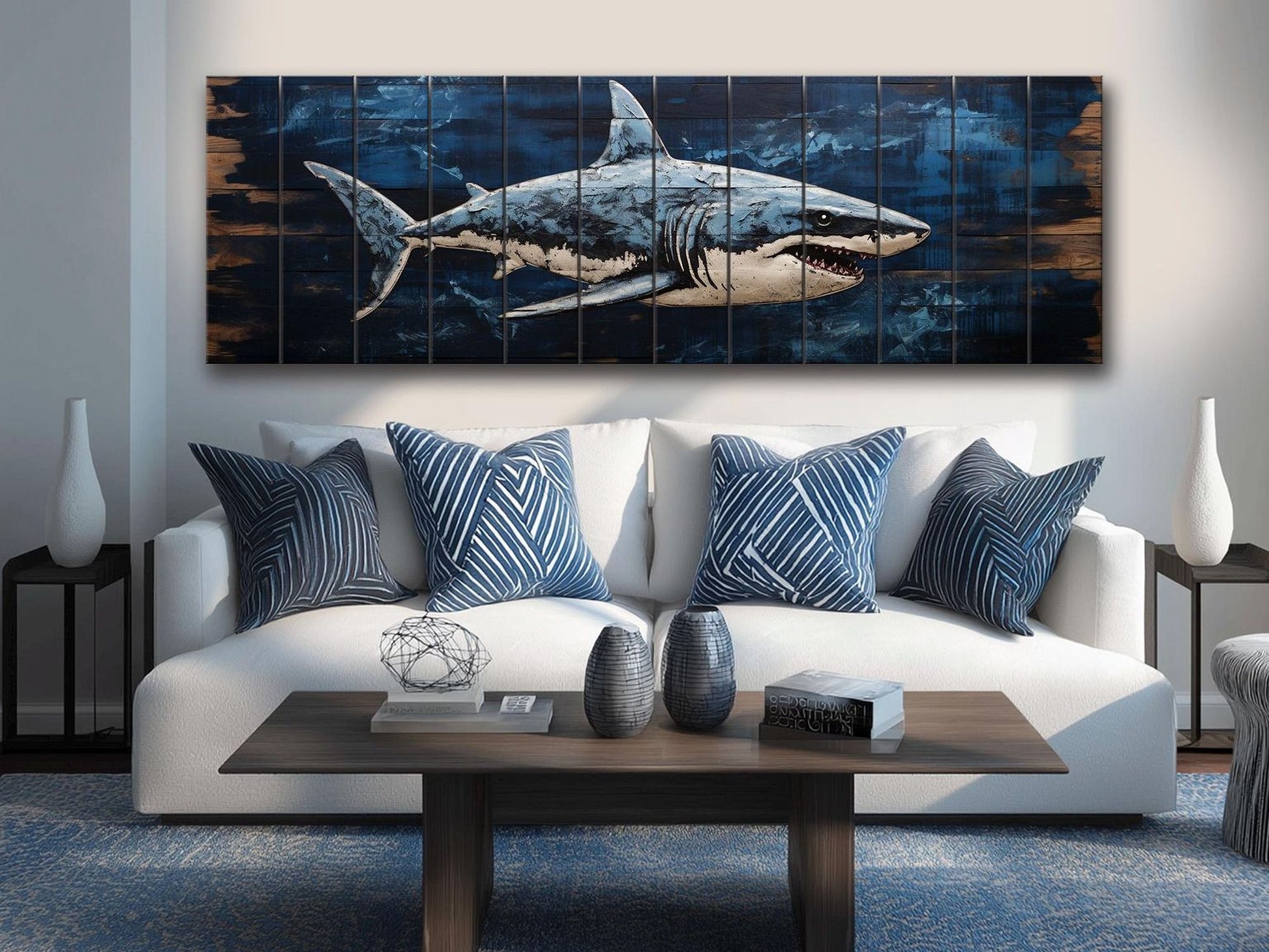 a living room with a white sofa adorned with blue and white patterned pillows. Above the sofa, there is a large wooden wall art depicting a shark. The room also includes a coffee table with decorative items, such as vases and books, and a rug on the floor.