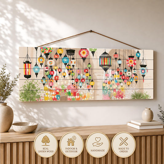 a wooden wall hanging with a vibrant display of colorful lanterns suspended from it. Below the hanging, there is a wooden shelf with decorative items such as a vase and a stack of books.