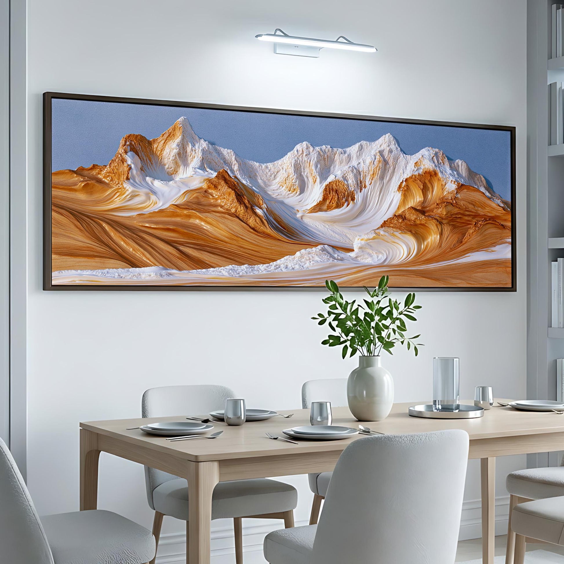 a large, framed painting of a mountain landscape hanging on a wall above a dining table with white chairs.