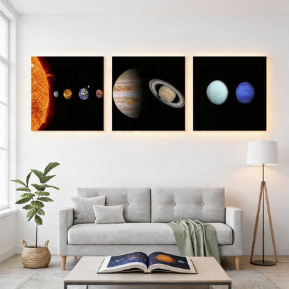 a modern living room with a gray sofa, a coffee table, and a potted plant. Above the sofa, there are three framed images depicting different planets in the solar system.
