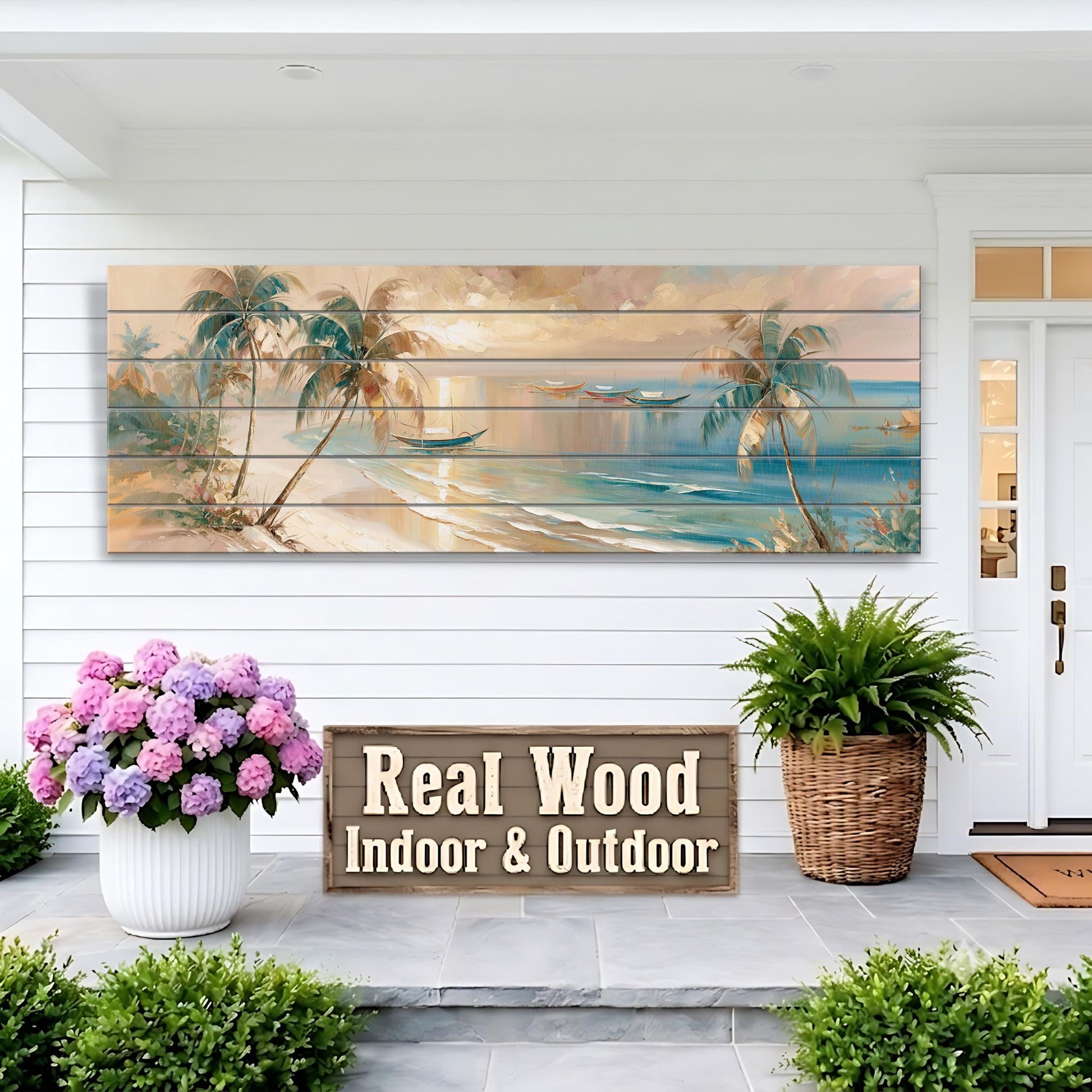 a large wooden panel hanging on a white wall, depicting a tropical beach scene with palm trees and a sunset. In front of the panel, there is a wooden sign that reads "Real Wood Indoor & Outdoor". Two potted plants are placed on the porch, one on the left and one on the right, adding a touch of greenery to the scene.