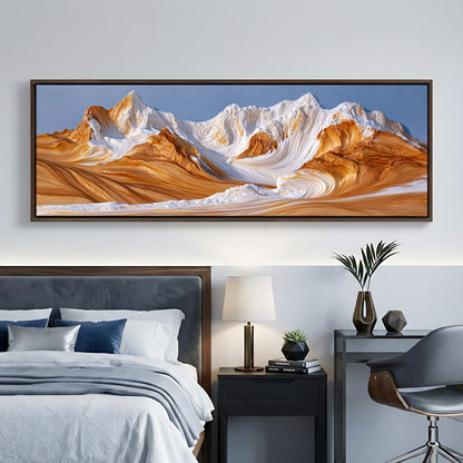 a large, framed landscape painting depicting a mountain range with a blue sky and orange and white peaks. The painting is hanging on a wall above a bed with a gray headboard.