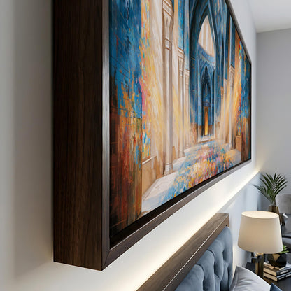 a large, colorful painting of a building with a blue and yellow color scheme, hanging on a wall in a room with a wooden frame.