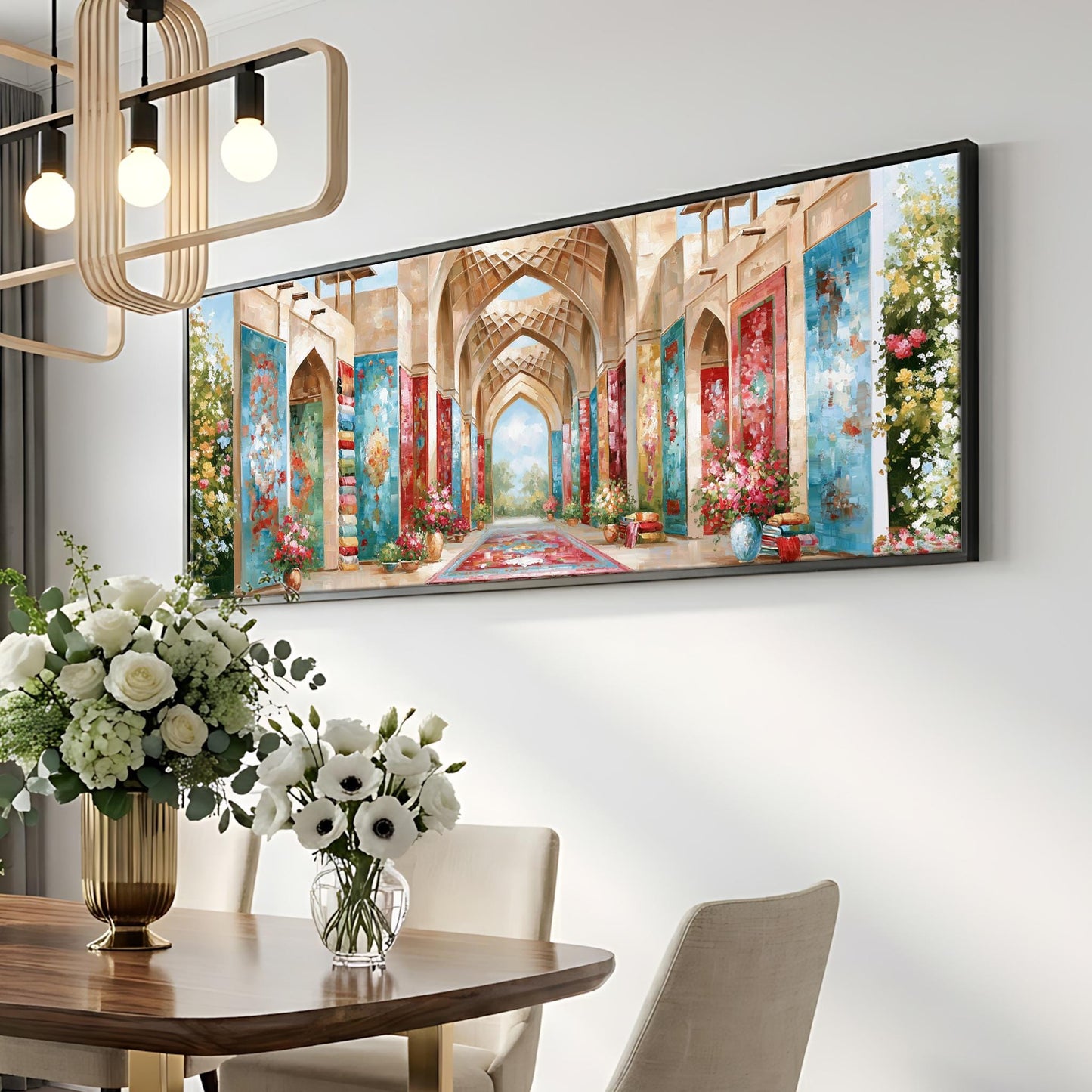 a large, colorful painting of an ornate, arched hallway with floral decorations hanging on the wall above a dining table with a vase of white flowers.