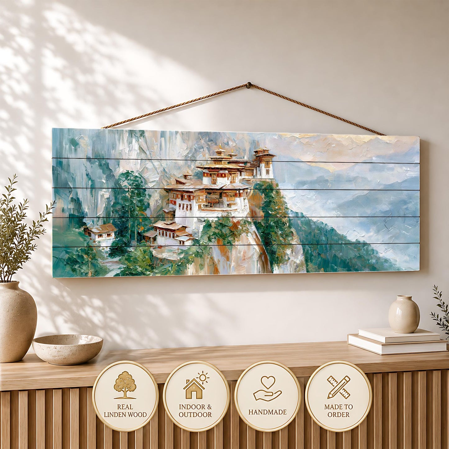 a wooden wall hanging depicting a picturesque mountain village with traditional architecture, surrounded by lush greenery.