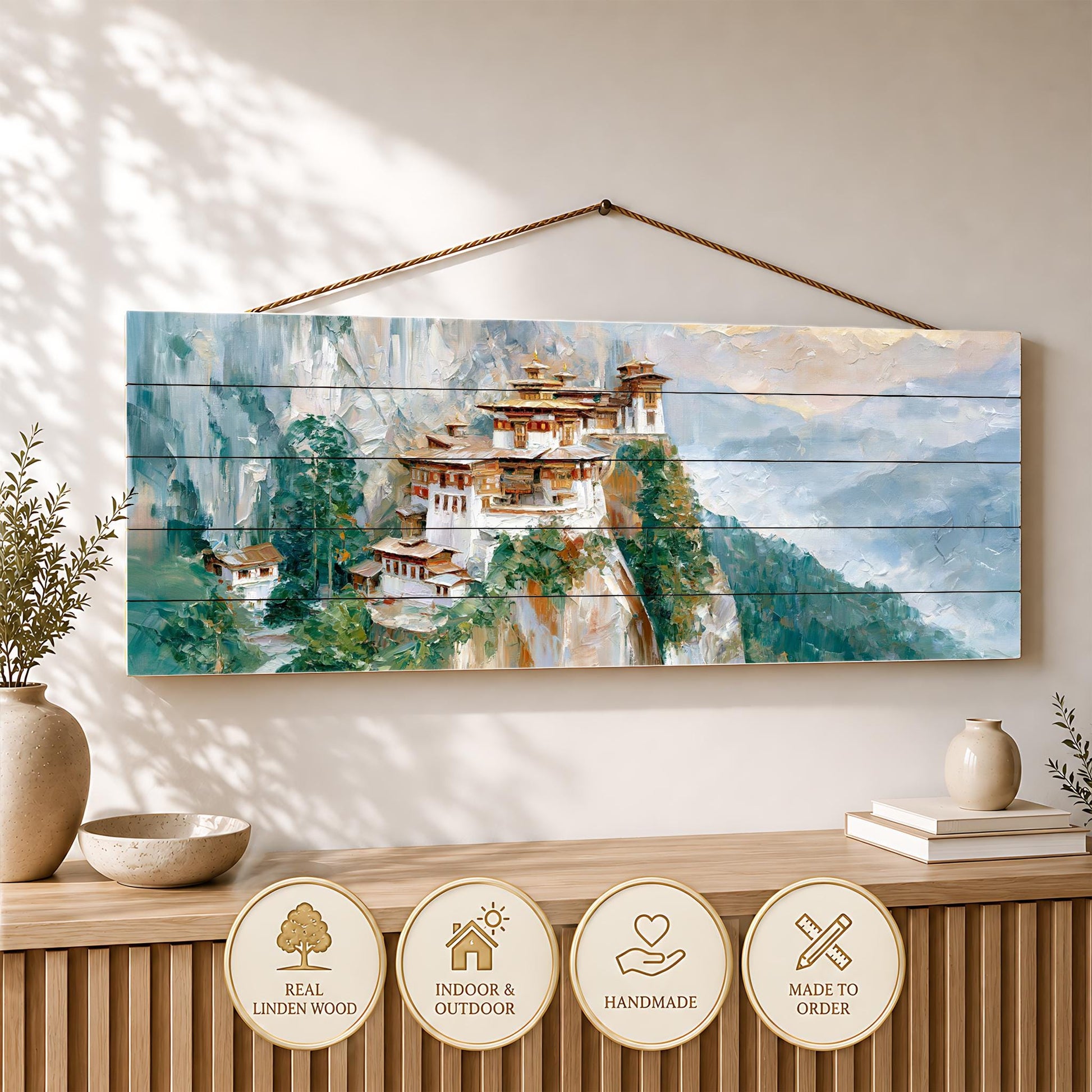 a wooden wall hanging depicting a picturesque mountain village with traditional architecture, surrounded by lush greenery.
