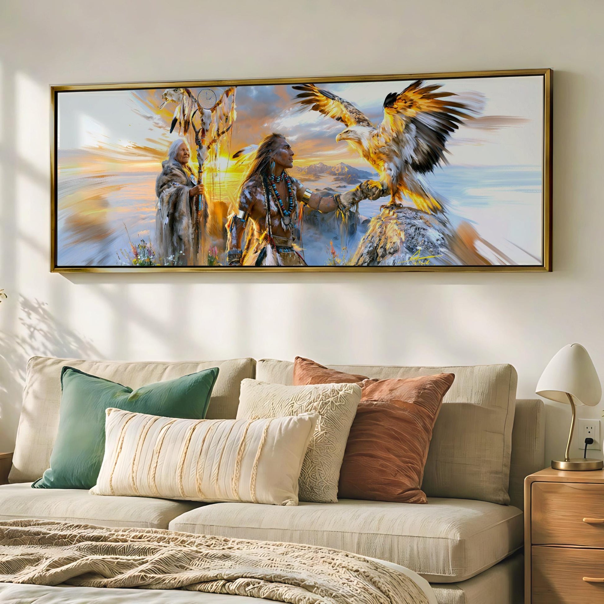 a large framed painting of Native American figures, including a Native American woman and a Native American eagle, displayed on a wall above a beige couch with decorative pillows.