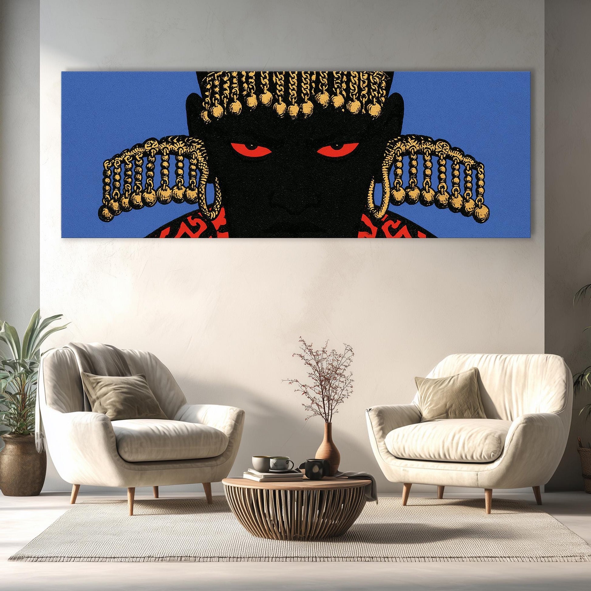 a large, colorful painting of a black face with gold accents hanging on a wall above a living room with two white armchairs and a coffee table.