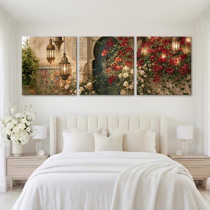A large, white bed with a white comforter and pillows, flanked by two nightstands with lamps. Above the bed are three large paintings depicting a garden scene with red flowers and a green archway.
