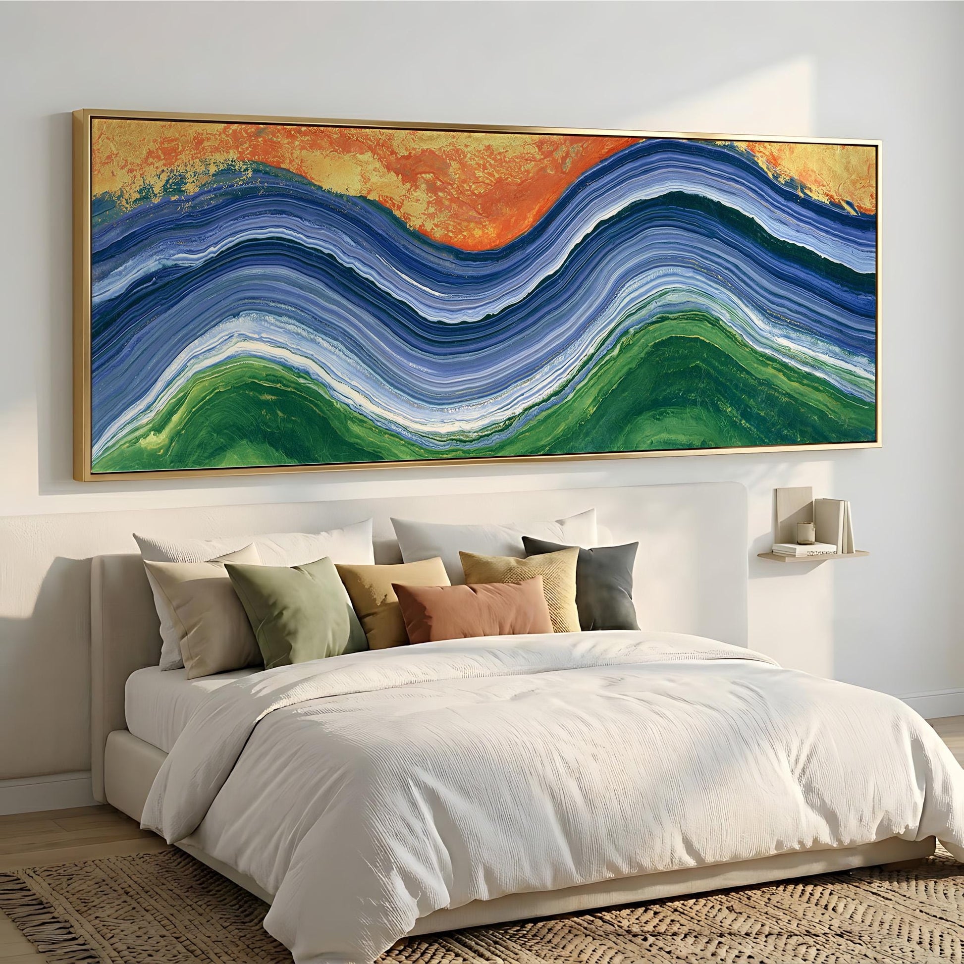 a large, colorful abstract painting hanging on a wall above a bed with white bedding and pillows.