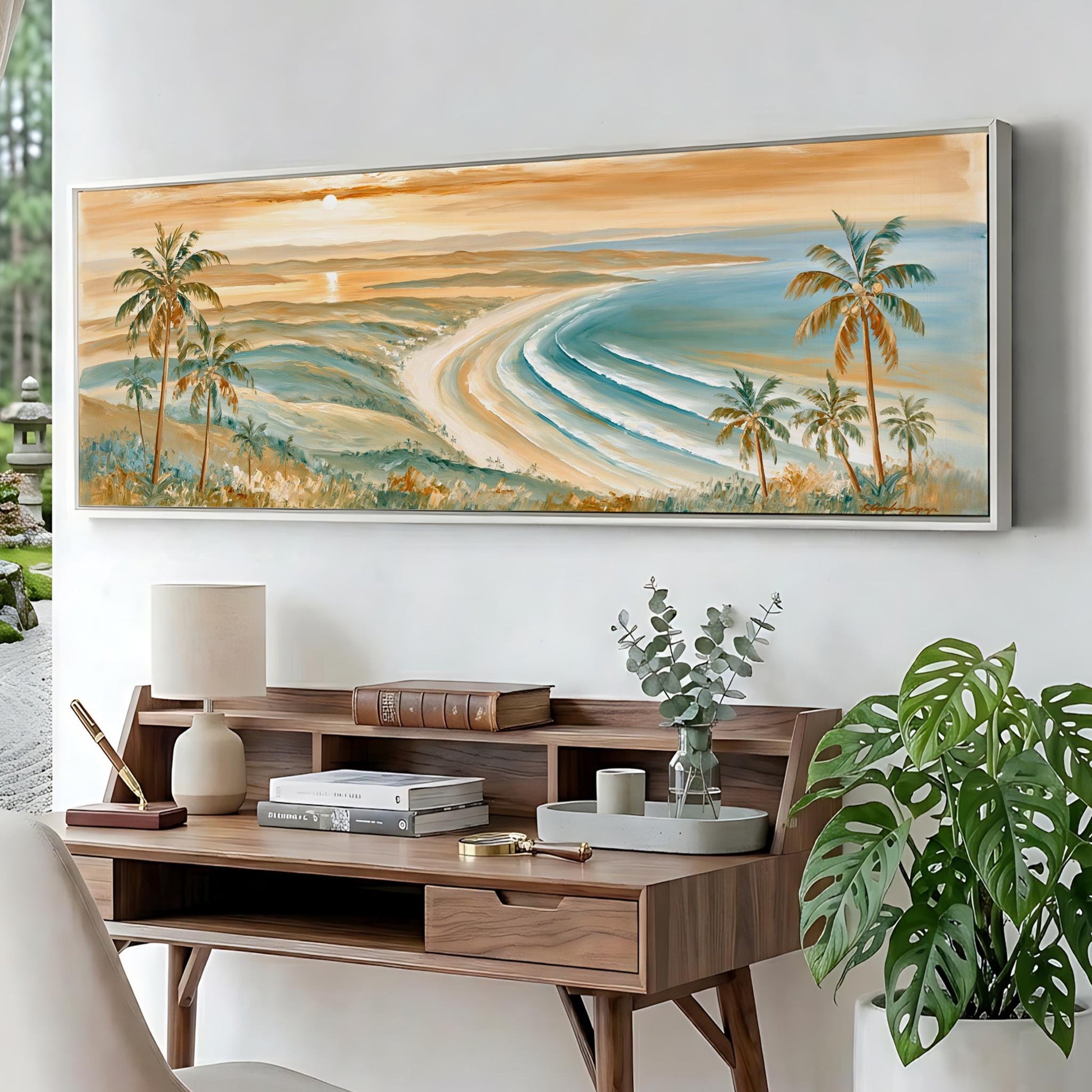 a large painting of a tropical beach scene hanging on a wall above a wooden desk with various items on it.