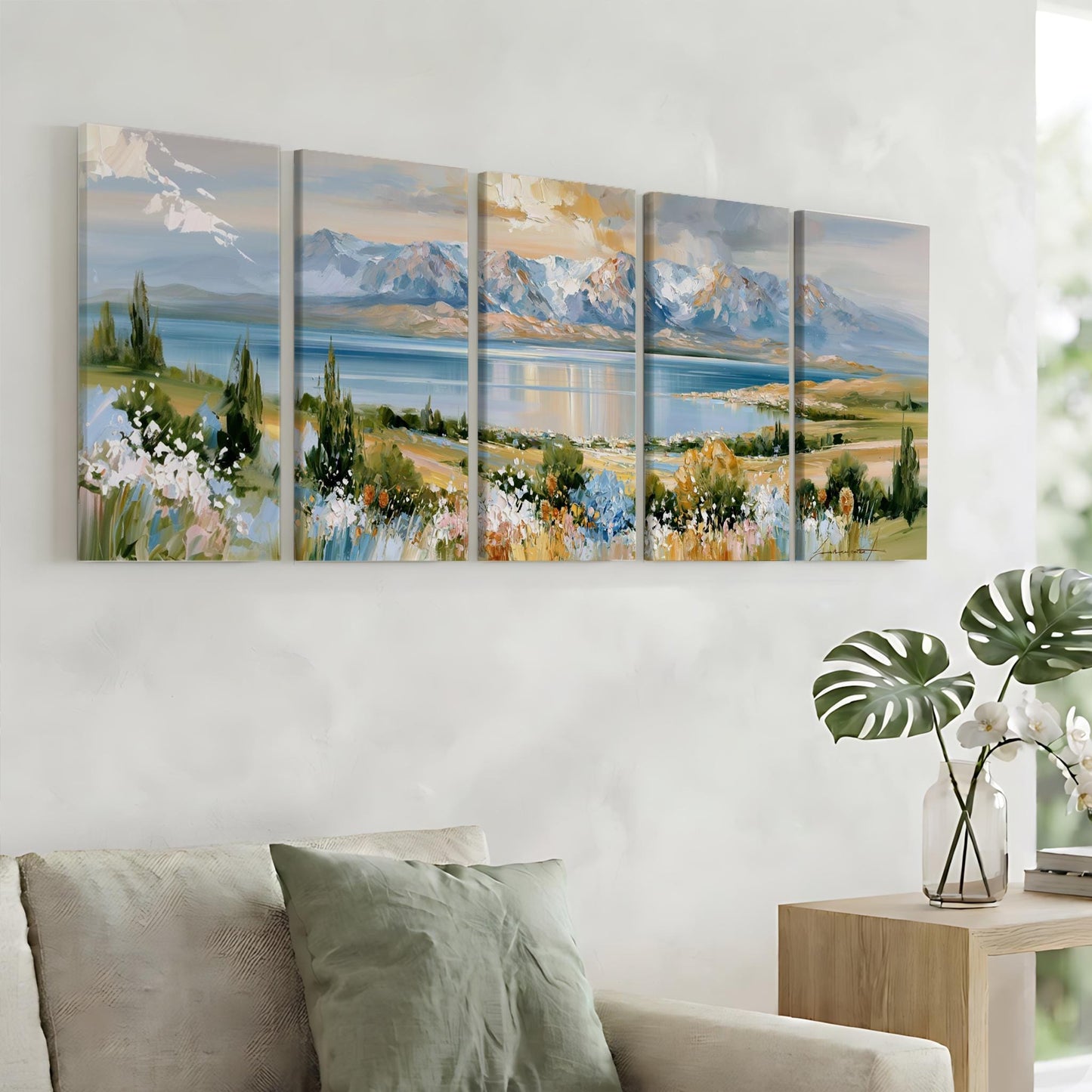a large, colorful painting of a landscape with mountains, flowers, and a lake, hanging on a wall above a couch in a living room.