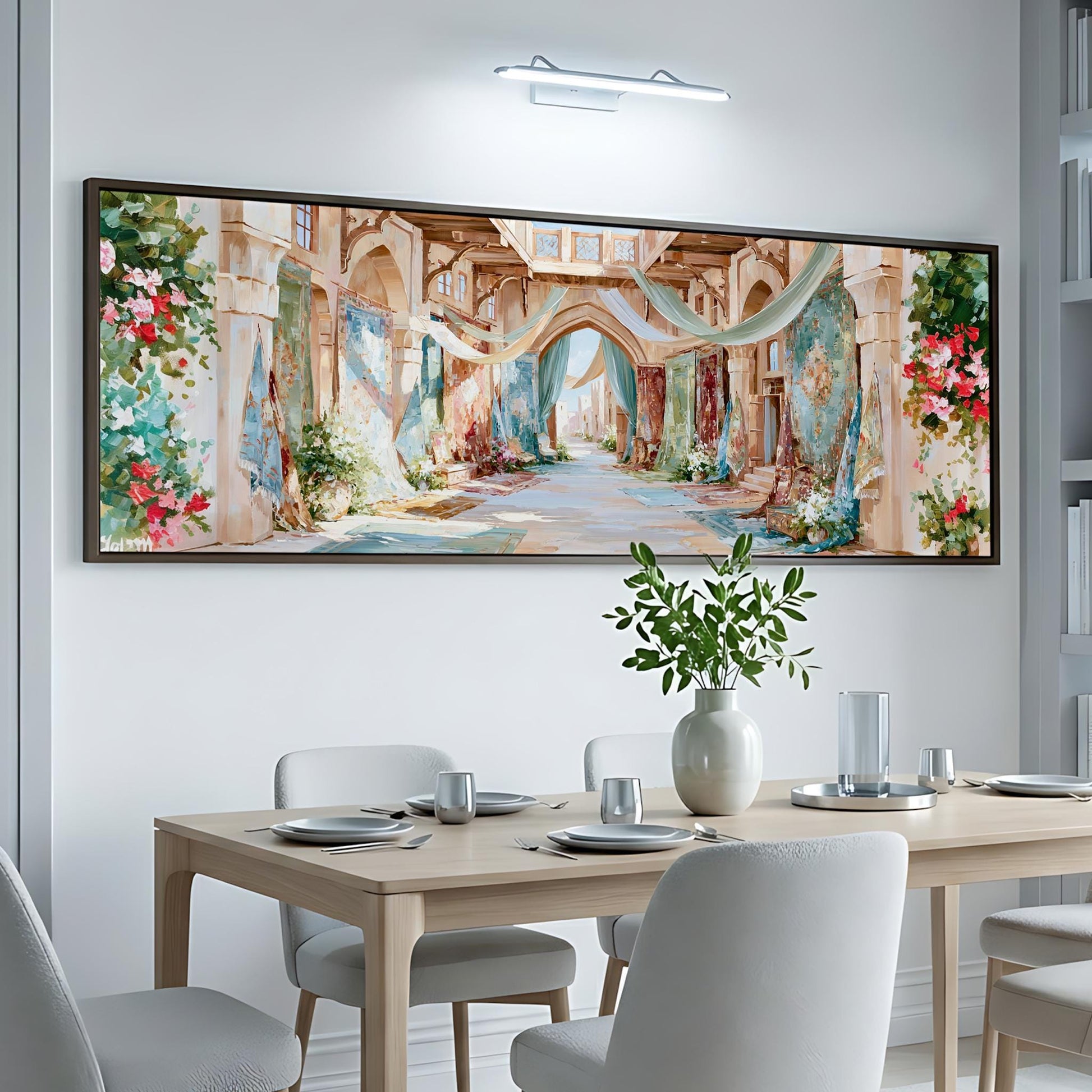 a large, colorful painting of a street scene hanging on a white wall above a dining table with chairs.