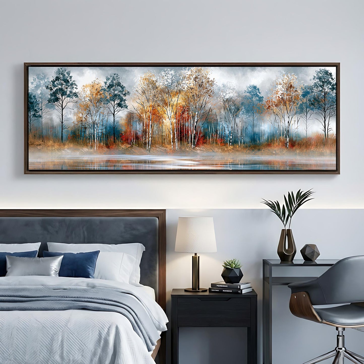 a bedroom with a large painting of a forest scene hanging on the wall above a bed. The painting depicts a serene landscape with trees in various shades of blue, orange, and brown, set against a calm body of water. The room also includes a nightstand with a lamp, a chair, and a small table with decorative items.