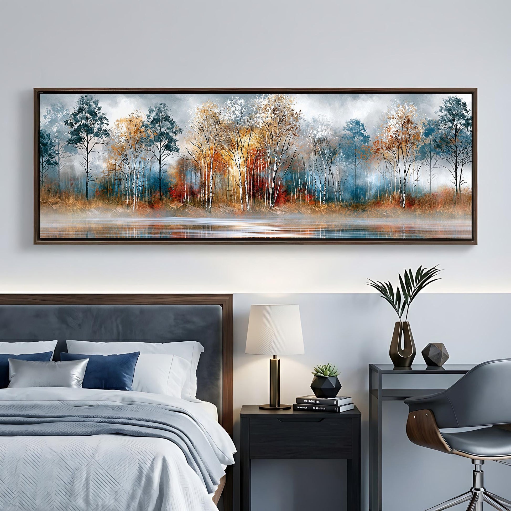 a bedroom with a large painting of a forest scene hanging on the wall above a bed. The painting depicts a serene landscape with trees in various shades of blue, orange, and brown, set against a calm body of water. The room also includes a nightstand with a lamp, a chair, and a small table with decorative items.